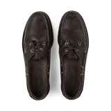 A pair of dark brown grained calf leather Paraboot boat shoes on a black background.