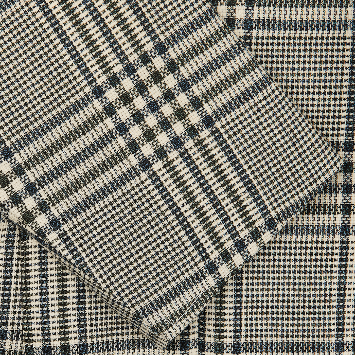Close-up view of a folded Blue Green Glen Check Balloon Wool Blazer fabric by Ring Jacket with visible textures, ideal for a lightweight wool jacket.