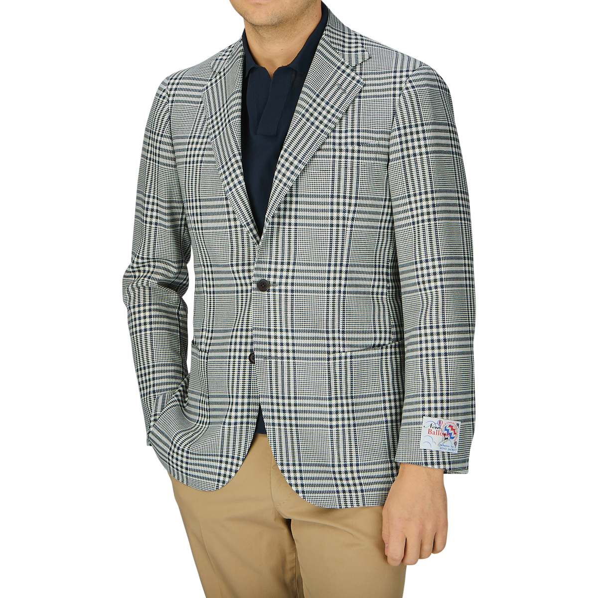 A man wearing a Ring Jacket Blue Green Glen Check Balloon Wool blazer, beige pants, and a dark shirt, photographed from neck to waist against a grey background.