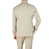 The back view of a man wearing a Ring Jacket Light Beige Herringbone Wool Suit.