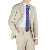 A man in a Light Beige Herringbone Wool Suit by Ring Jacket.