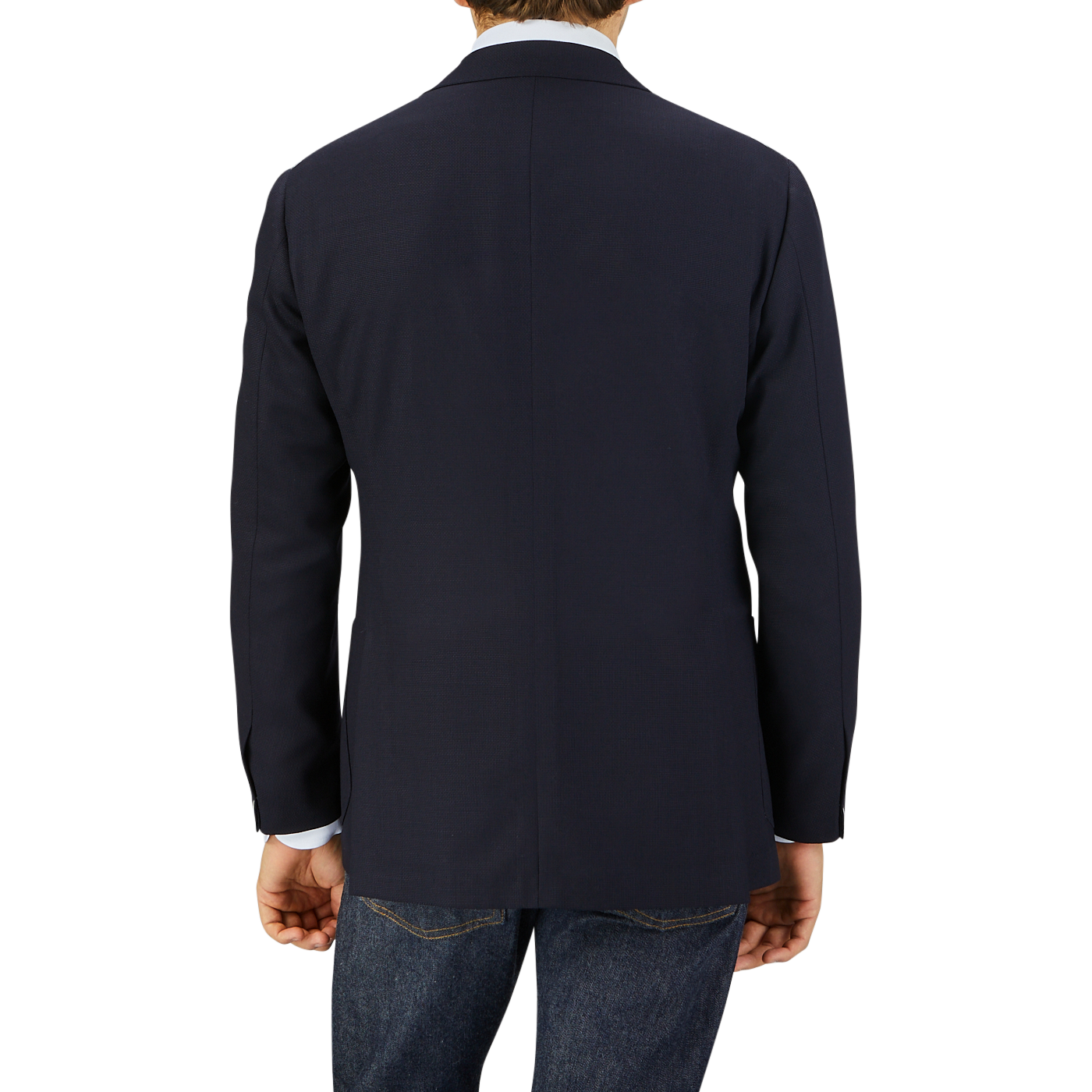 Rear view of a man wearing a Ring Jacket Navy Blue Wool Balloon Travel Blazer and jeans, standing against a light grey background.