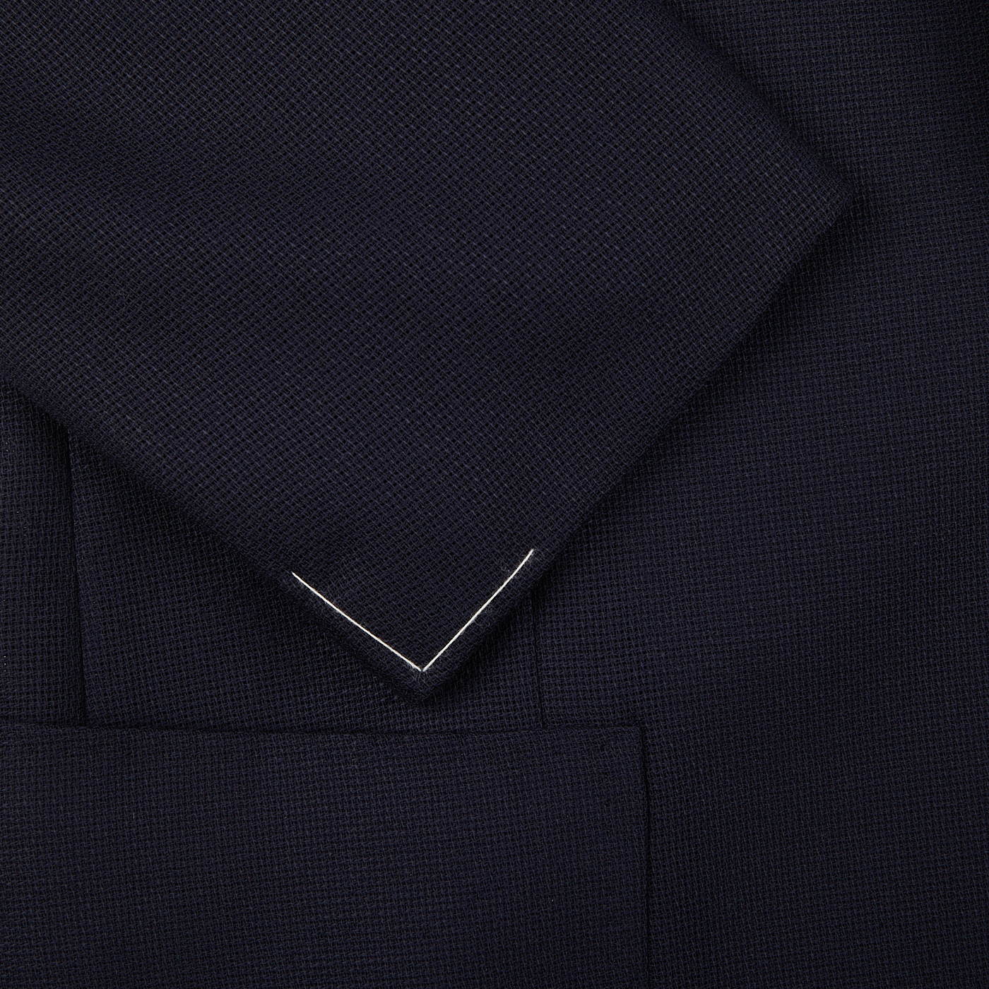 Close-up view of a Navy Blue Wool Balloon Travel Blazer from Ring Jacket, showing detailed weave pattern and a pointed lapel.
