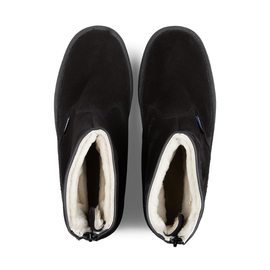 A pair of original black slip-on Sanders shoes with white lining, viewed from above.