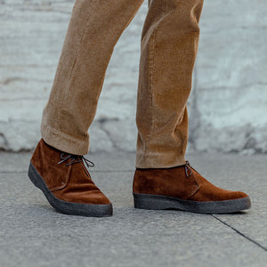 A man wearing a pair of Sanders Polo Snuff Suede Hi Top Boots.