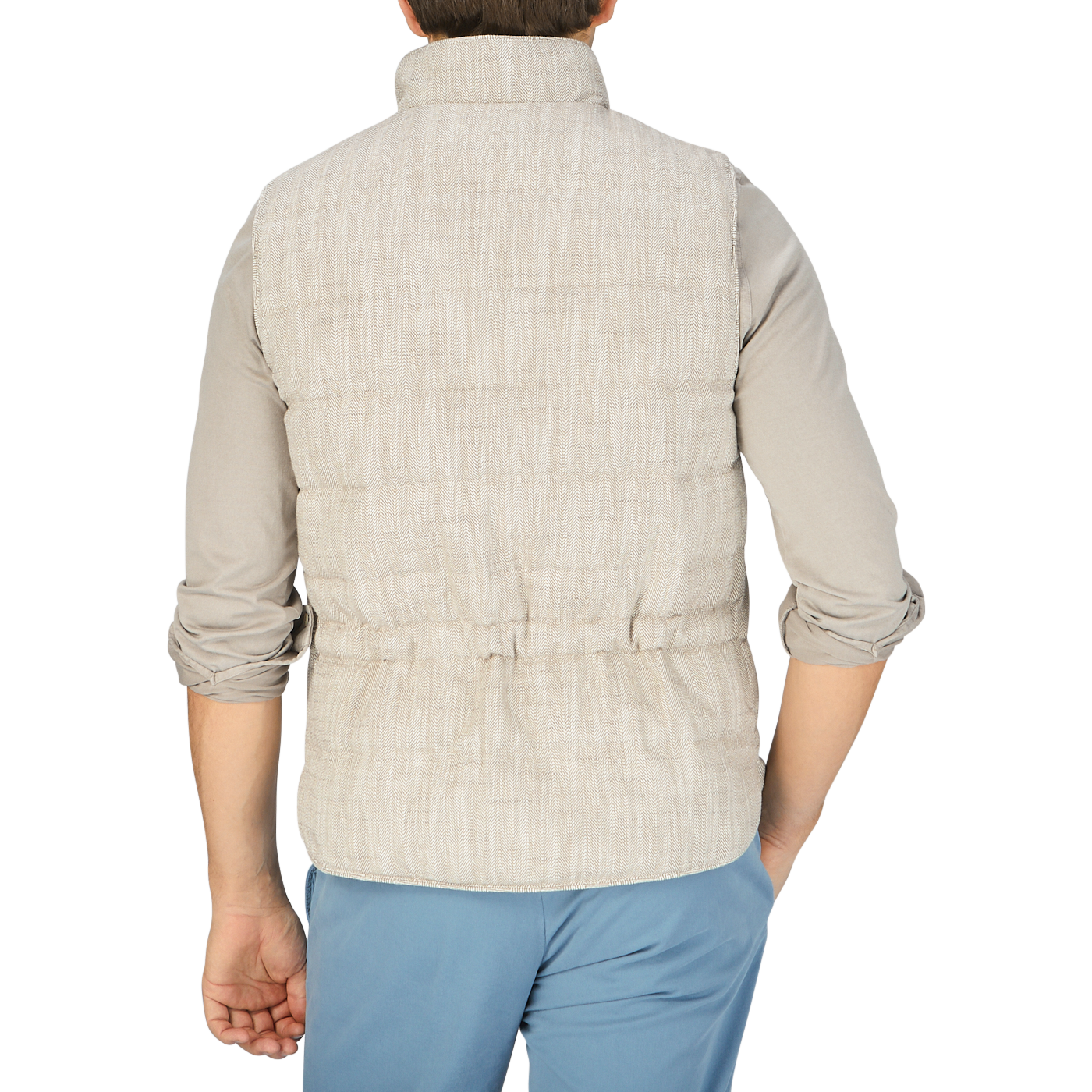 The back view of a man wearing a Beige Herringbone Cotton Linen Down Padded Gilet, a layering piece from Stenströms.