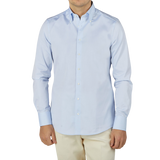 A man wearing a Stenströms Light Blue Cotton Oxford BD Fitted Body Shirt and tan pants.