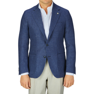A person wearing a dark blue Studio 73 Checked Wool Linen Blazer, white shirt, and light-colored trousers.