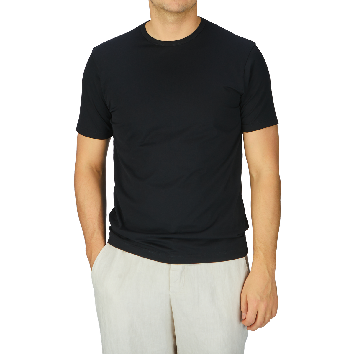 A man wearing a comfortable Sunspel Black Classic Cotton T-Shirt and white pants.