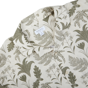 A Ecru Katie Scott Printed Resort Shirt with a green and beige botanical design by artist Katie Scott.