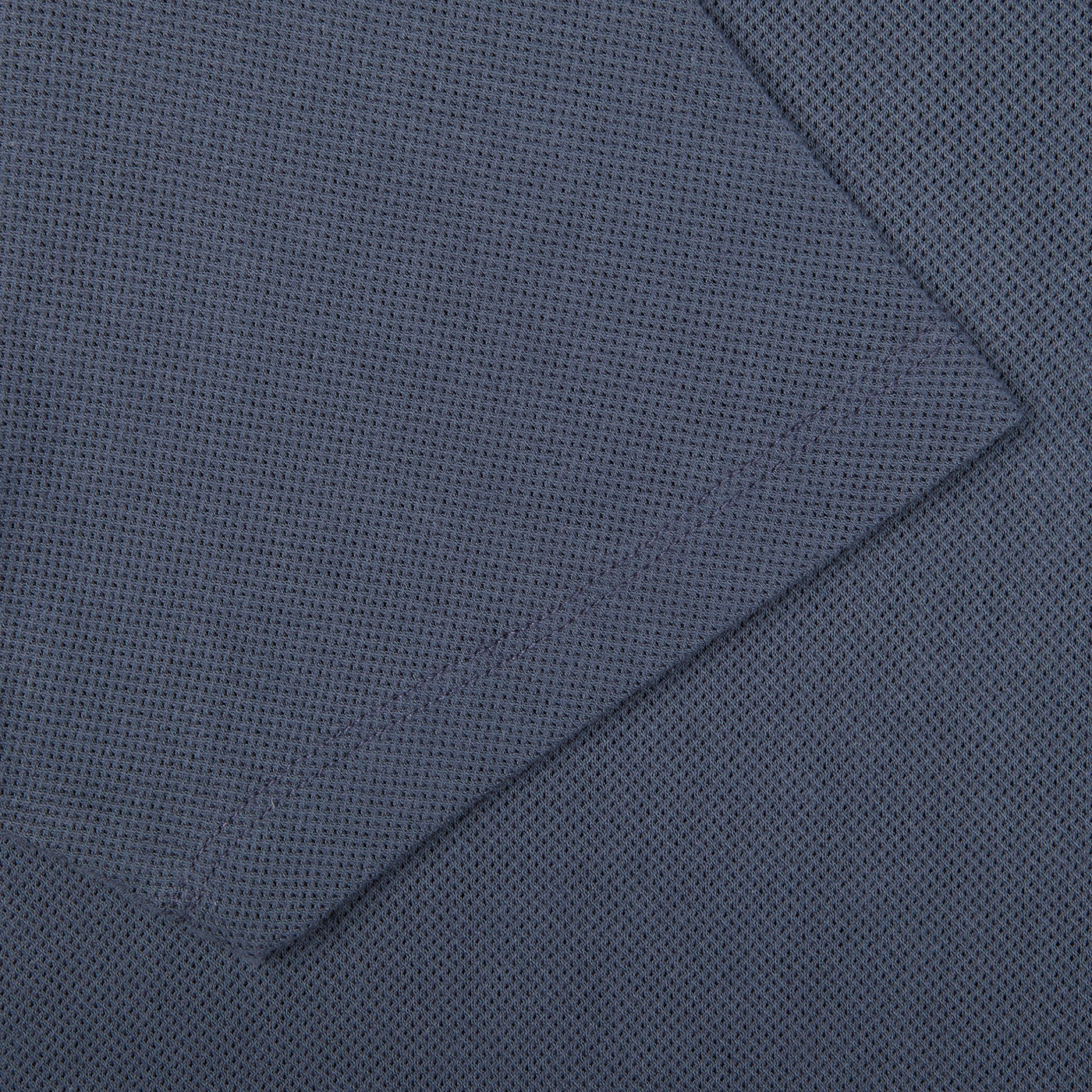 A close up of a slate blue Sunspel Riviera Polo Shirt.