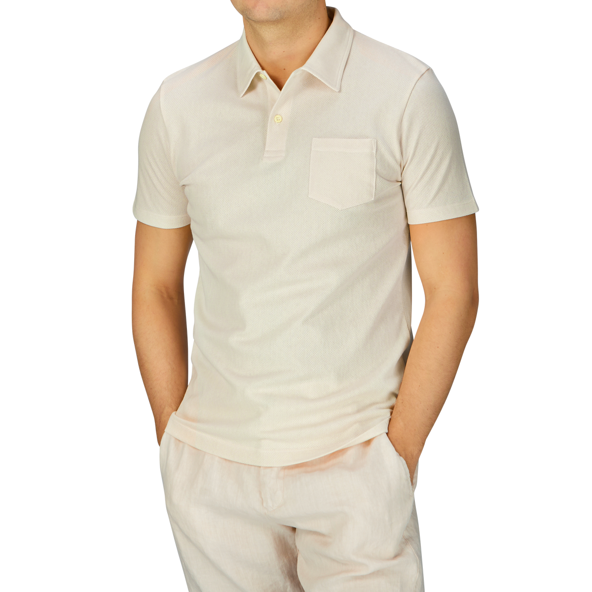 A man dressed in an Undyed Cotton Riviera Polo Shirt by Sunspel.
