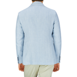 Man wearing a Tagliatore Light Blue Herringbone Linen Wool Vesuvio Blazer and pastel green pants, viewed from the back.