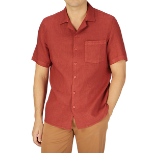 A man wearing a Brick Red Renato Linen Camp Collar Shirt by Tela Genova, giving off a summer feel.