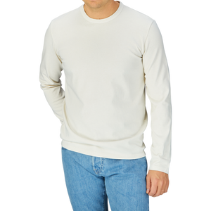 Man wearing a Off-White Heavy Organic Cotton LS T-Shirt by Tela Genova and blue jeans by Tela Genova.