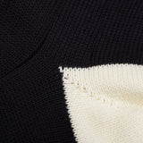 Close-up of a frayed edge where William Lockie navy blue cotton contrast cable-knit socks meet.