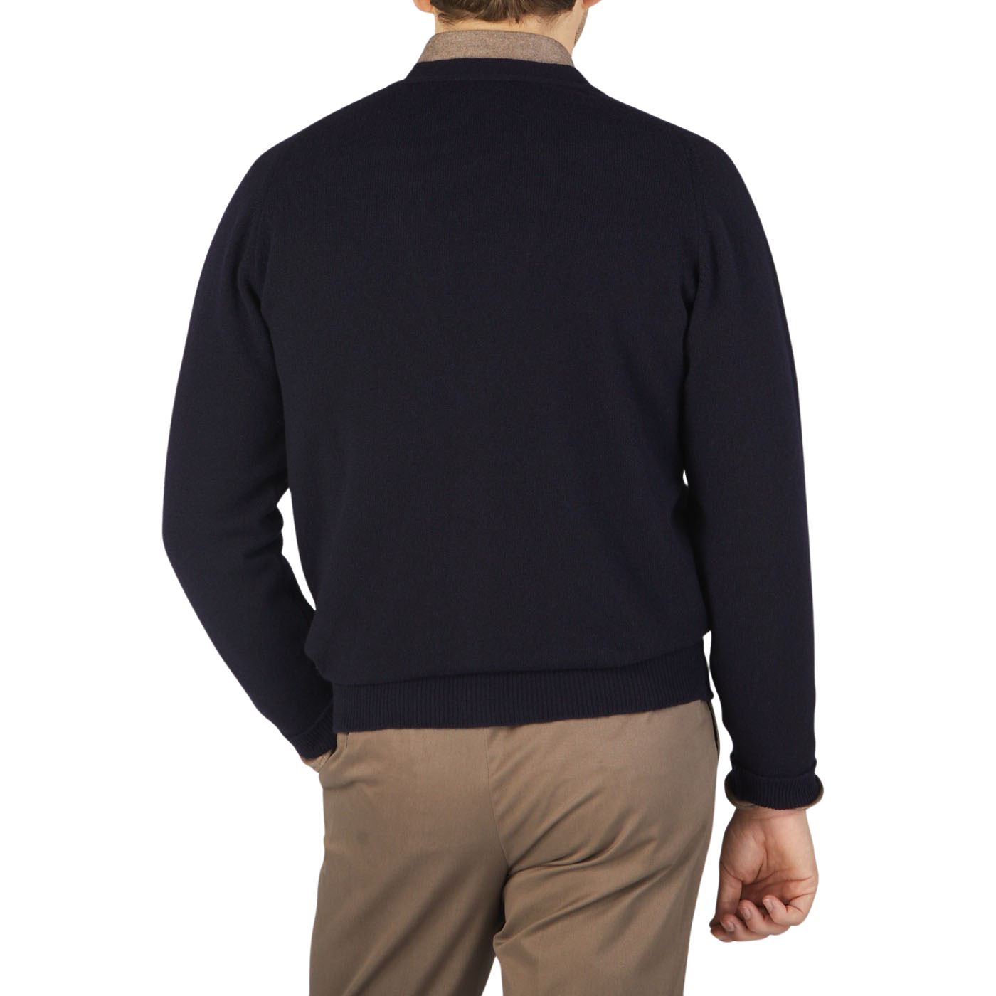 The back view of a man wearing a William Lockie Navy Lambswool Saddle Shoulder Cardigan and tan pants.