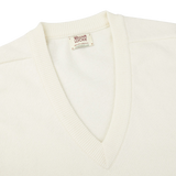 An Off-White Deep V-Neck Lambswool Sweater by William Lockie on a white background.