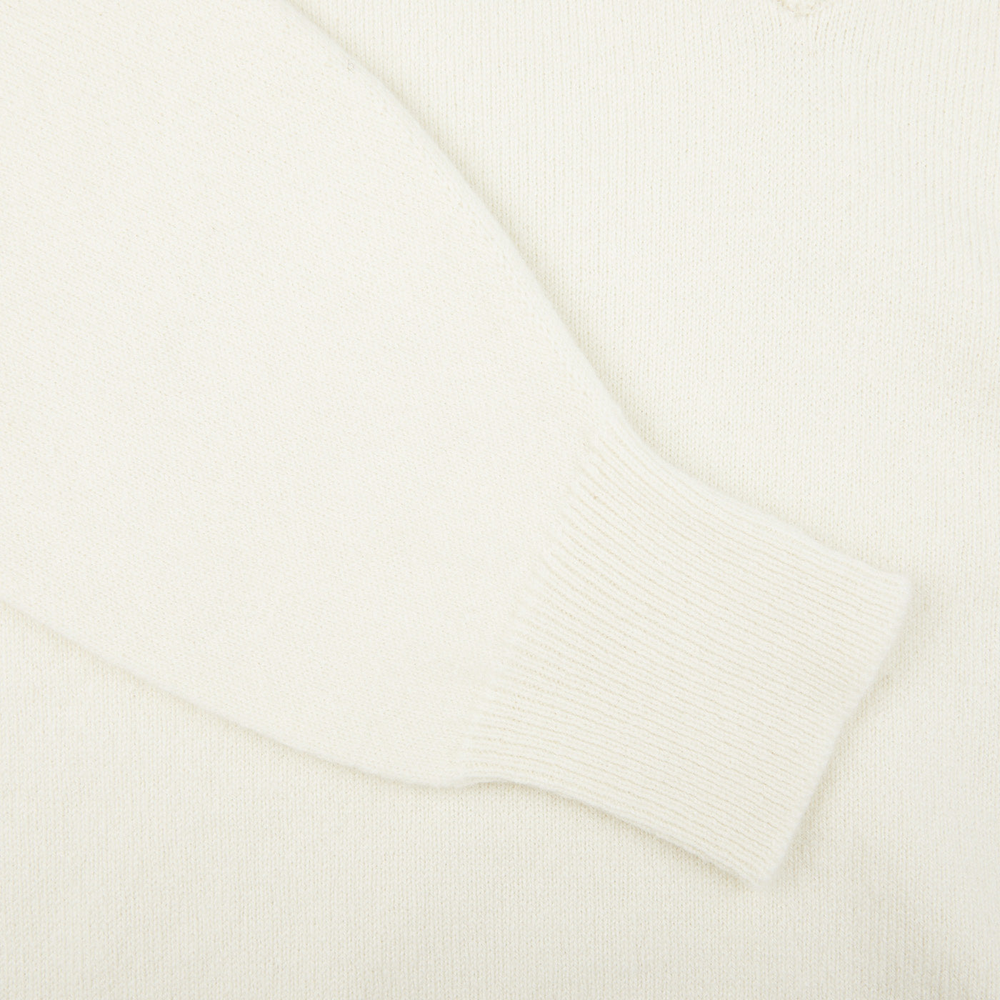 A close up image of a William Lockie Off-White Deep V-Neck Lambswool Sweater.