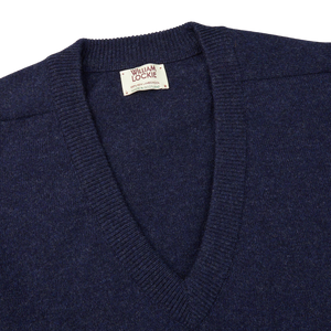 A William Lockie Oxford Blue Deep V-Neck Lambswool Sweater with a label on it.