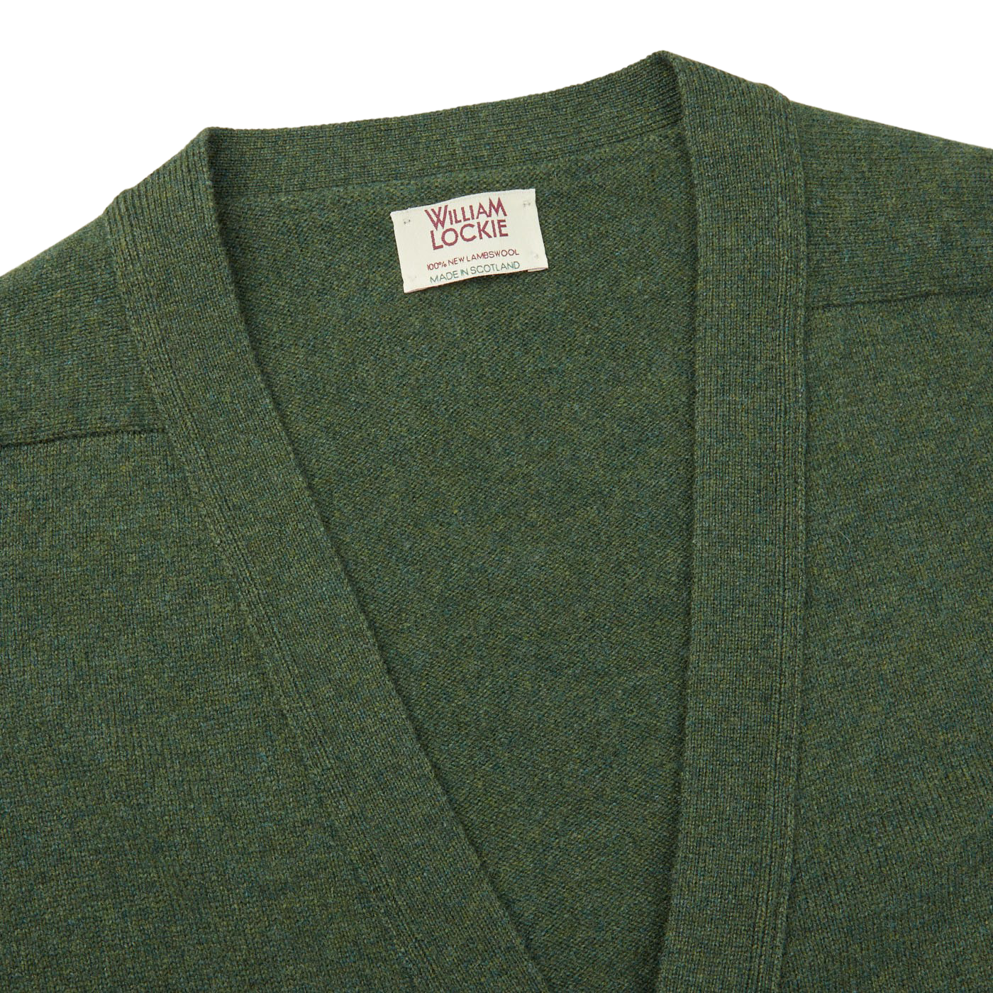A William Lockie Rosemary Green Lambswool Saddle Shoulder Cardigan with a label on it, perfect for layering.