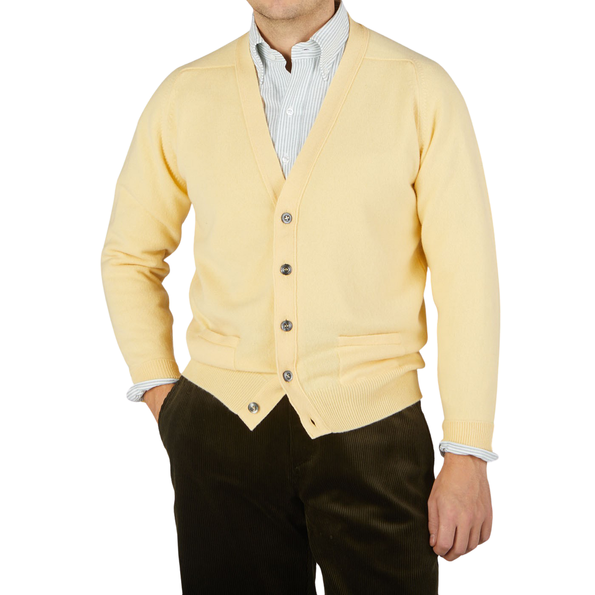 A man wearing a William Lockie Solar Yellow Lambswool Saddle Shoulder Cardigan.