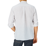 Man seen from behind wearing a Regular Fit, Beige Striped Washed Linen Legacy Shirt by Xacus and denim jeans.