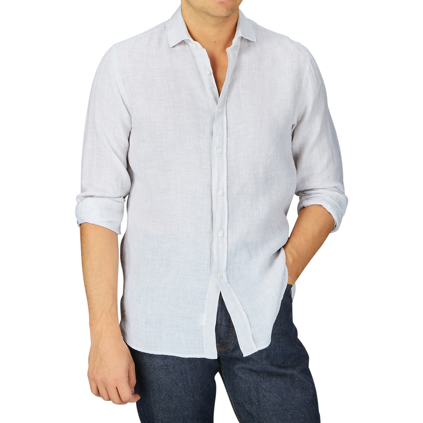 Man wearing a Xacus beige striped washed linen legacy shirt and dark jeans, with the shirt partially untucked.