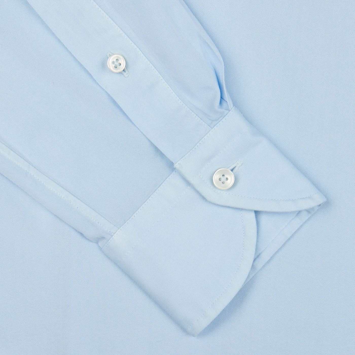 Xacus Light Blue Twill Tailor Fit Shirt with buttoned cuffs on a light blue background.