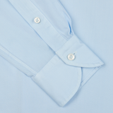 Xacus Light Blue Twill Tailor Fit Shirt with buttoned cuffs on a light blue background.
