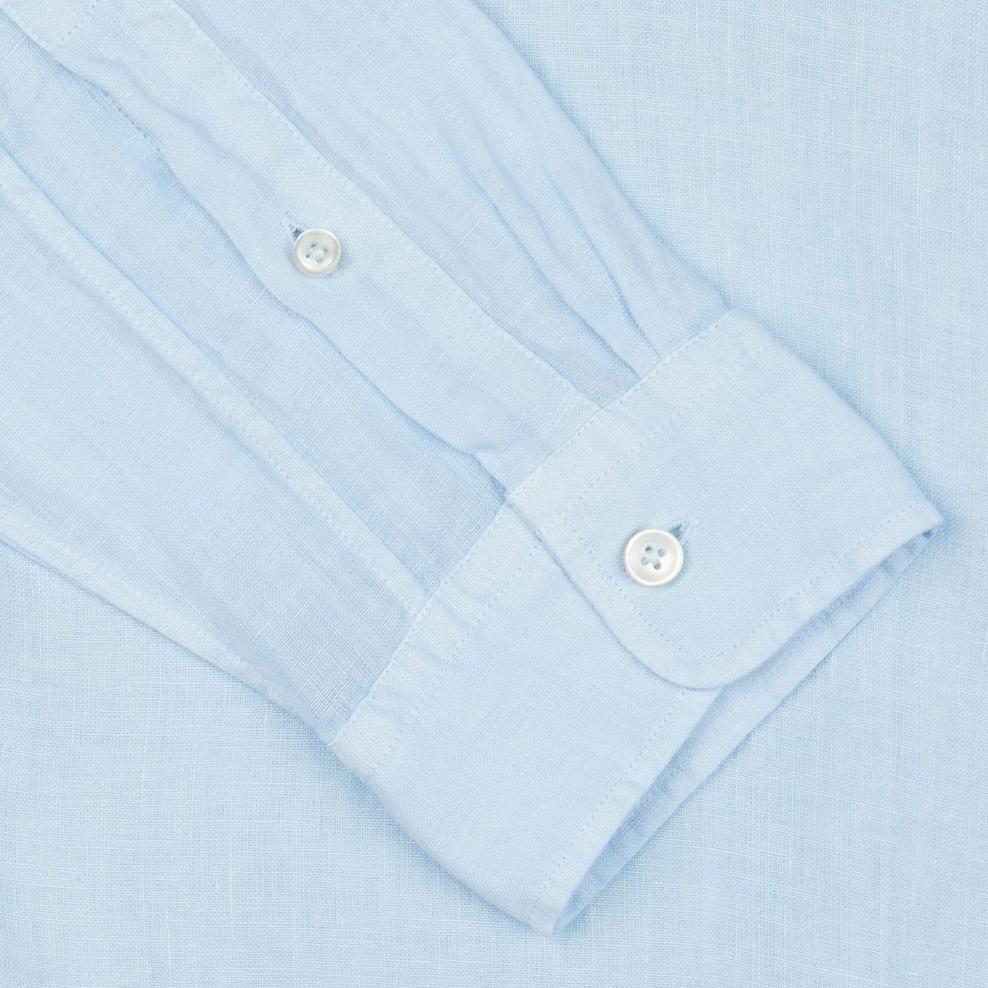 Close-up of a Xacus Light Blue Washed Linen Legacy Shirt cuff with buttons.