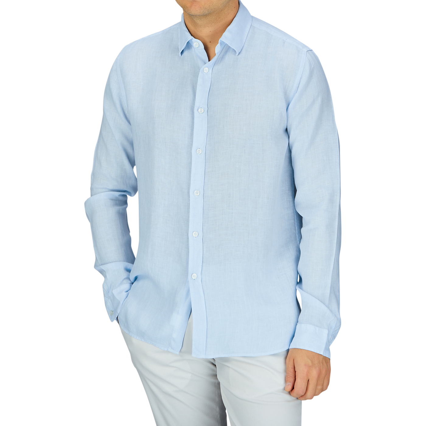 Man wearing a Xacus Light Blue Washed Linen Legacy Shirt in a regular fit and white trousers.