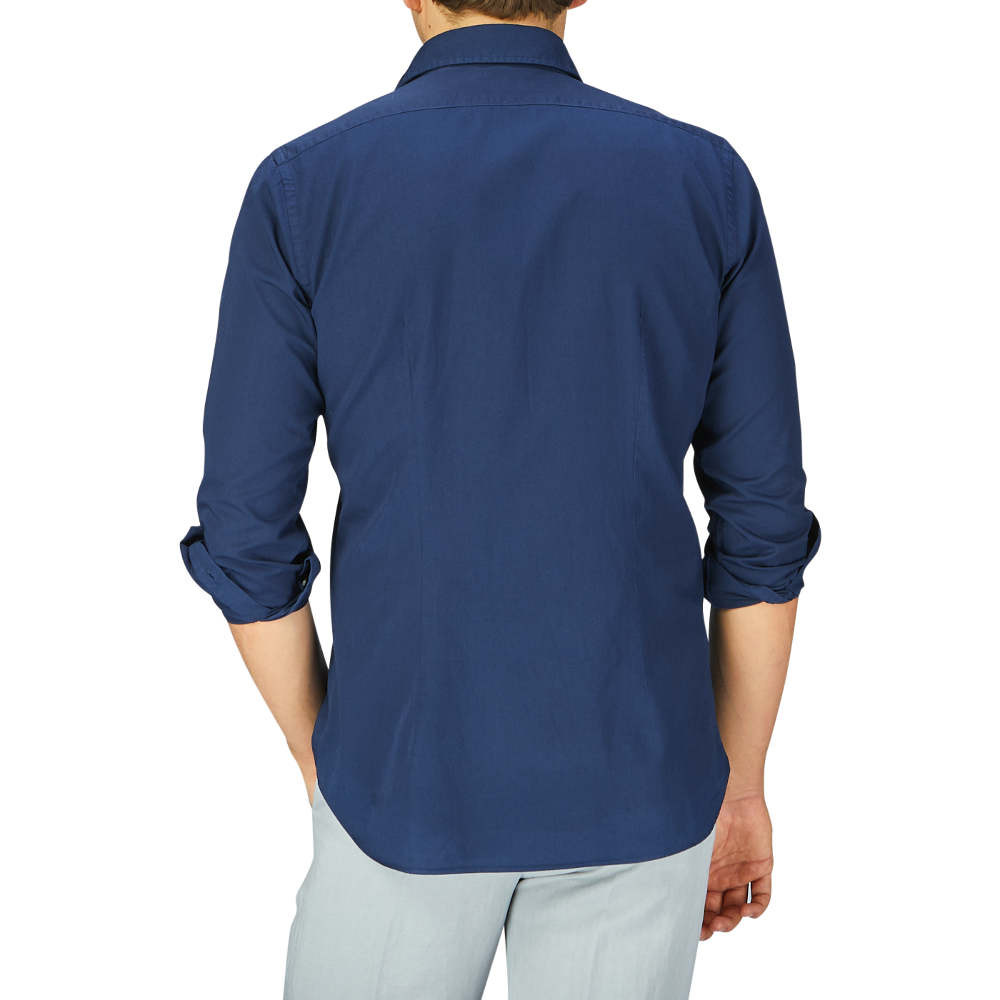 A man seen from behind wearing a rolled-up sleeve Xacus navy blue cotton twill tailor fit shirt and light-colored pants.