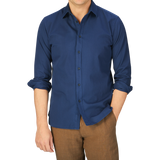 Man wearing a Xacus Navy Washed Cotton Twill Legacy Shirt and brown trousers.