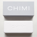 A white box with the word Chimi on it, featuring Chimi Eyewear's Steel Round Grey Lenses Sunglasses 50mm.