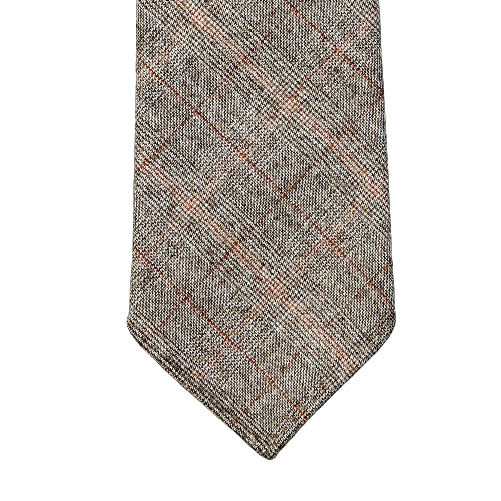 A gray and brown plaid Dreaming Of Monday handmade tie on a gray background.