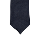 An elegant Navy Blue 7-Fold Wool Hopsack tie on a white background, handmade with unlined construction for a stylish and sophisticated drape from Dreaming Of Monday.