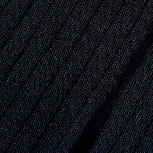 A close up image of a comfortable navy ribbed knit sweater made with Pantherella's Navy Merino Wool Ribbed Knee Socks.