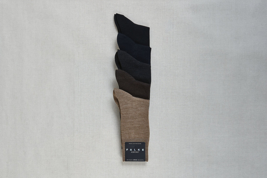 A set of folded falke socks in gradient shades displayed on a fabric background.
