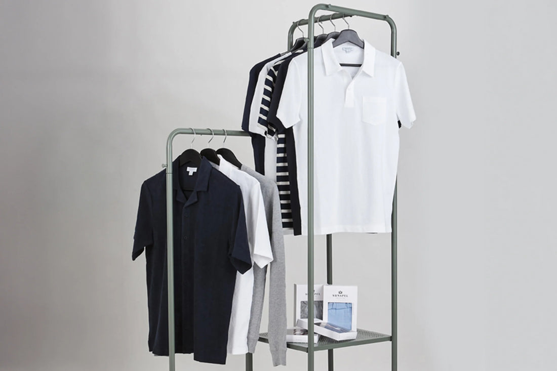 Assorted polo shirts on display racks with a minimalist backdrop.