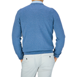 A person from behind wearing an Alan Paine Airforce Blue Luxury Cotton V-Neck Sweater and white pants.