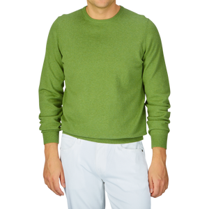 Man wearing a Avocado Green Luxury Cotton Crewneck by Alan Paine and white pants.