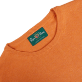 Close-up of the label on a Blazing Orange Luxury Cotton Crewneck by Alan Paine.