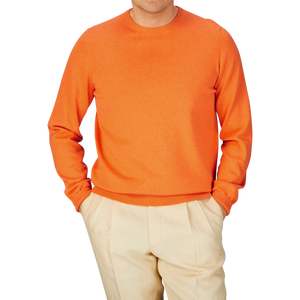 Man wearing an Alan Paine Blazing Orange Luxury Cotton Crewneck and beige pants.