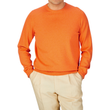 Man wearing an Alan Paine Blazing Orange Luxury Cotton Crewneck and beige pants.