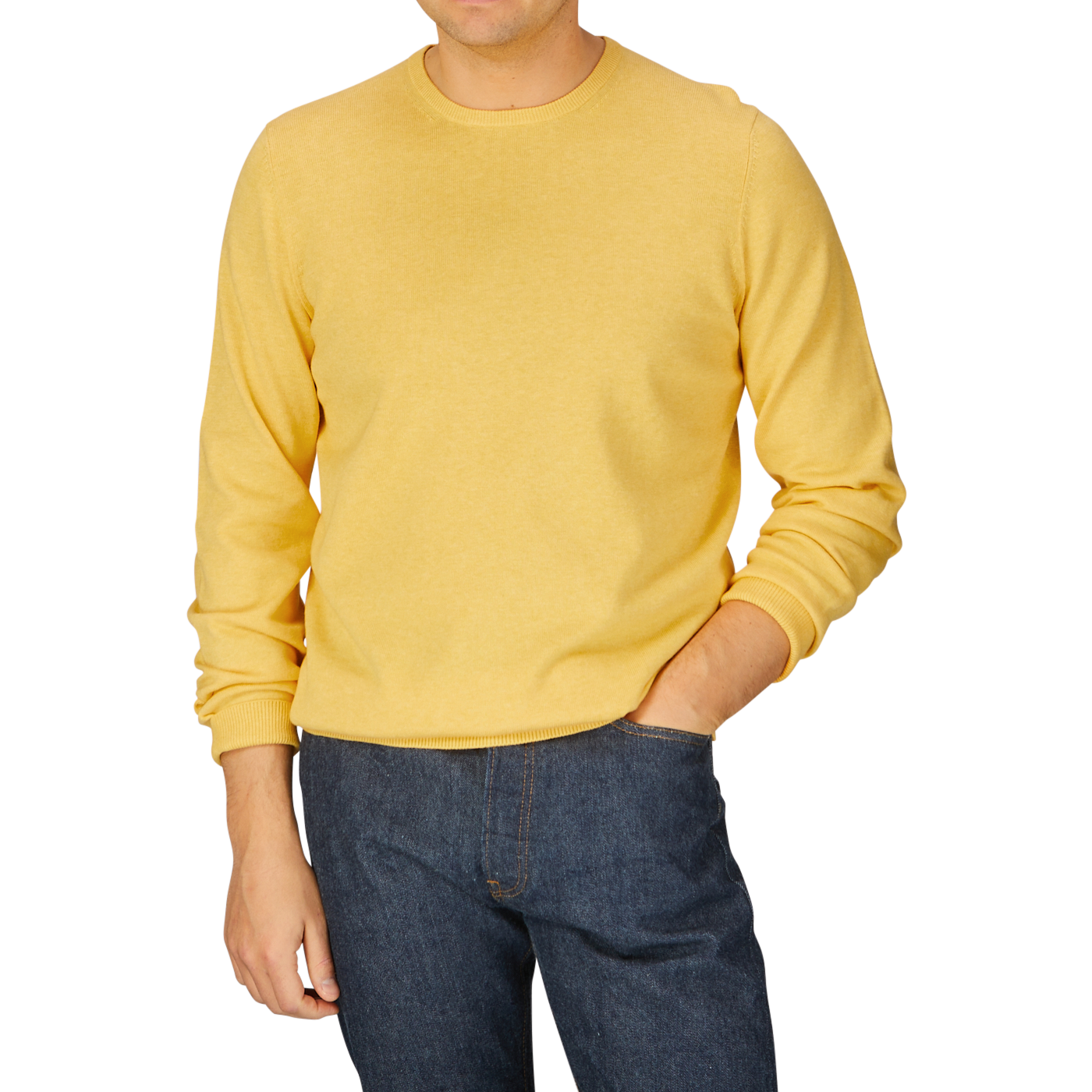 Man wearing a luxury cotton corn yellow Alan Paine crewneck sweater and blue jeans.