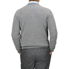 A man wearing the Grey Melange Lambswool Crew Neck by Alan Paine and grey trousers is photographed from the back against a plain background.