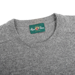 Close-up image of the Grey Melange Lambswool Crew Neck by Alan Paine, featuring a green label that reads "Alan Paine, England" sewn into the inside of the collar.