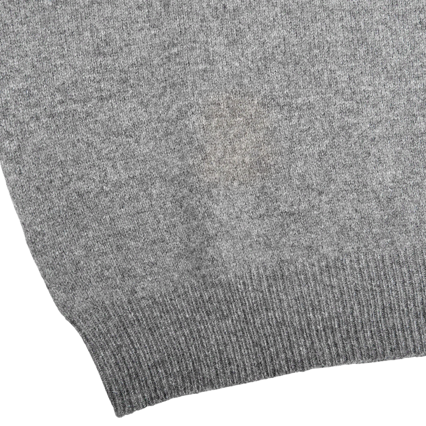 Close-up of the Alan Paine Grey Melange Lambswool Crew Neck, featuring a small discolored patch in the center. The edge of the fabric showcases a ribbed texture, reminiscent of a classic crew neck sweater.