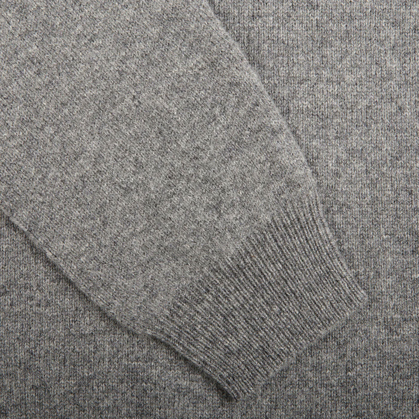 Close-up view of a Grey Melange Lambswool V-Neck sweater sleeve by Alan Paine with ribbed cuffs.